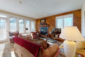 a living room with a couch and a television at Sun Vail 24B in Vail