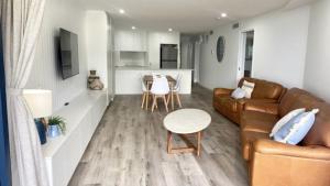 a living room with a couch and a table at Grand Pacific Unit 10 in Caloundra