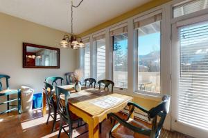 a dining room with a wooden table and chairs at Sun Vail 24B in Vail