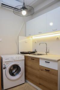 a kitchen with a washing machine and a sink at Cozy Twins - Petra in Kavála