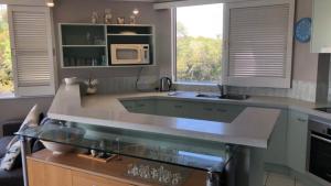 a kitchen with a counter top and a microwave at Outlook Unit 7 in Kawana Waters