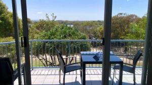 a patio with a table and chairs on a balcony at Outlook Unit 7 in Kawana Waters