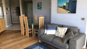 a living room with a couch and a table at Outlook Unit 7 in Kawana Waters