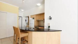 a kitchen with a black counter top in a room at Rolling Surf Resort Unit 48 in Caloundra