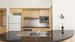 a kitchen with a sink and a microwave at Rolling Surf Resort Unit 48 in Caloundra