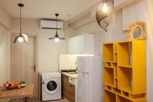 a kitchen with a white refrigerator and a washing machine at Cozy Twins - Petra in Kavála
