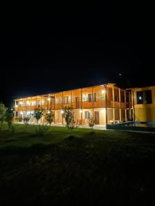 a large building at night with its lights on at Ani Center Hotel in Dovekh