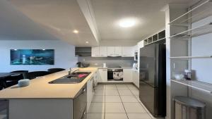 a kitchen with a sink and a counter top at Seabourn Unit 502 in Caloundra +11 photos
