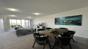 a living room with a table and chairs at Seabourn Unit 502 in Caloundra