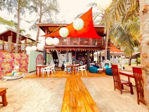 a patio with tables and chairs in front of a house at Surf & Turf in Arugam Bay