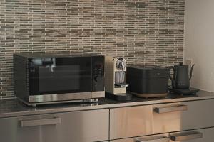 a microwave sitting on top of a kitchen counter at TOKIWA葛城-katsuragi- in Shinjō +28 photos