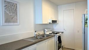 a kitchen with a sink and a stove at Pumicestone Chase Unit 5 in Caloundra