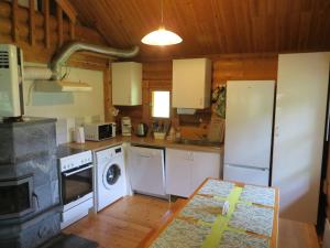 a kitchen with white appliances and a stove at Cottage-karaoke Koivikko in Äänekoski