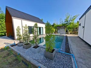 a house with a swimming pool next to a house at Thegrandstargoodview in Ban Na +21 photos