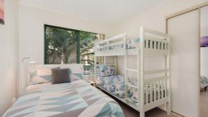a bedroom with two bunk beds and a ladder at Unit 2 'fair Haven' Kings Beach in Caloundra