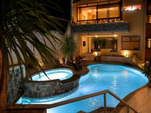 a swimming pool in a hotel at night at 1775 Adriatico Suites in Manila