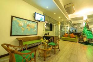 a living room with a couch and a christmas tree at Rain Tree by Oak Ray in Tissamaharama