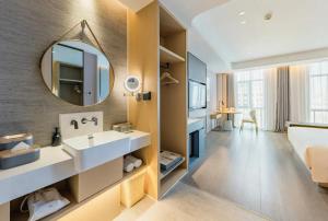 a bathroom with a sink and a mirror at Atour Hotel Altay in Altay +66 photos