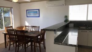 a kitchen and dining room with a table and chairs at Sorrento Unit 5 in Golden Beach +8 photos