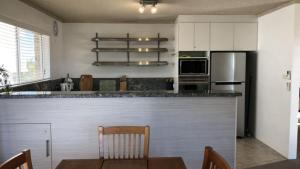 a kitchen with a bar with a table and a counter top at Sorrento Unit 5 in Golden Beach