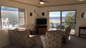 a living room with two chairs and a television at Sorrento Unit 5 in Golden Beach