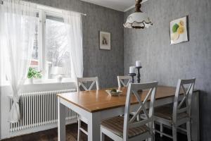 a dining room with a wooden table and chairs at Private Villa with parking - Skellefteå in Skellefteå