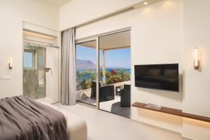 a bedroom with a large window with a view at Sal hotel Kissamos in Kissamos