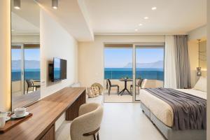 a hotel room with a bed and a view of the ocean at Sal hotel Kissamos in Kissamos +89 photos
