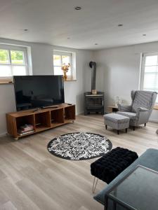 a living room with a large flat screen tv at Hof Busen Farm Haus in Mönchengladbach