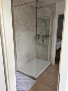 a shower with a glass door in a bathroom at Hof Busen Farm Haus in Mönchengladbach +9 photos