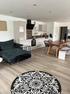a living room with a couch and a table at Hof Busen Farm Haus in Mönchengladbach