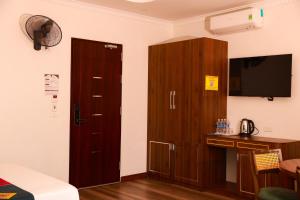 a room with wooden cabinets and a tv and a bed at Harmony Haven Hotel in Sapa