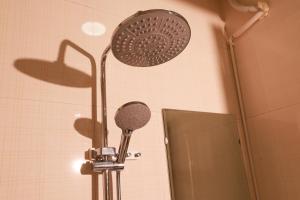 a shower head in a bathroom with a mirror at Harmony Haven Hotel in Sapa +60 photos