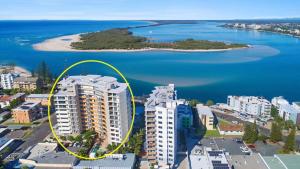 a yellow circle on top of a building near the water at Amazing Views, Walk Everywhere! in Caloundra