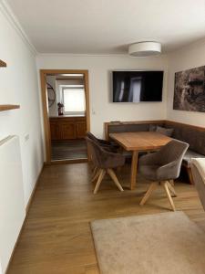 a living room with a wooden table and chairs at Haus Hubertus in Wagrain