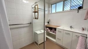 a bathroom with a shower and a toilet and a sink at Drakes Hideaway in Golden Beach +2 photos
