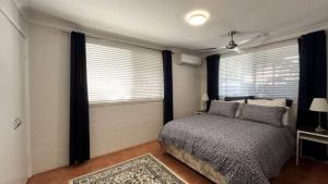 a bedroom with a bed and a window at Drakes Hideaway in Golden Beach