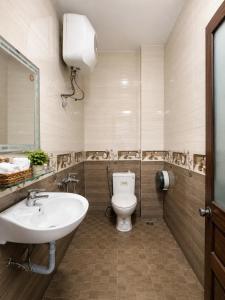 a bathroom with a white toilet and a sink at Thiên Ngân Hostel in Da Lat