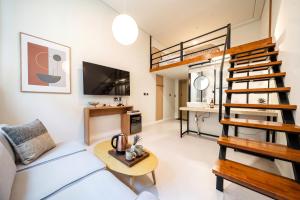a living room with a loft bed and a couch at Restia Hotel Suwon Station in Suwon