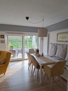 a living room with a table and chairs and a couch at Villa Arboreta in Tuhelj