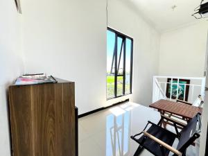 a room with a table and chairs and a window at MP Villa Boulvard 43 Malang in Blimbing