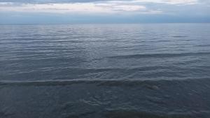a large body of water with some waves at Кафе Кочевник in Chon-Sary-Oy +3 photos