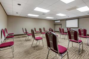 a conference room with red chairs and a white screen at Comfort Inn West Hazleton in West Hazleton