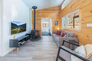 a living room with a couch and a fireplace at Spa & Riverside - Le Ptit Cool Des Bois in Trois Rives