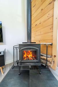 a stove with a fire in a room at Spa & Riverside - Le Ptit Cool Des Bois in Trois Rives +43 photos