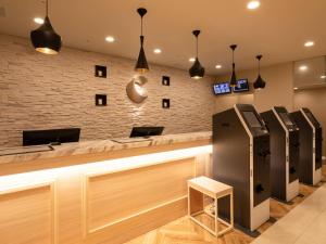 a bar in a barber shop with a cash register at Comfort Hotel ERA Kobe Sannomiya in Kobe