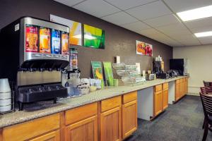 a coffee shop with a counter in a room at Quality Inn Stadium Area Green Bay Stadium in Green Bay