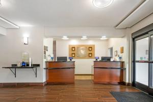 a lobby with two reception desks in a room at Comfort Inn & Suites Covington - Mandeville in Covington