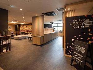 a library cafe with a sign in the middle of a room at Comfort Hotel ERA Kyoto Toji in Kyoto