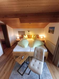 a bedroom with a bed and a table and chairs at Pension Sonnenhof in Mieming